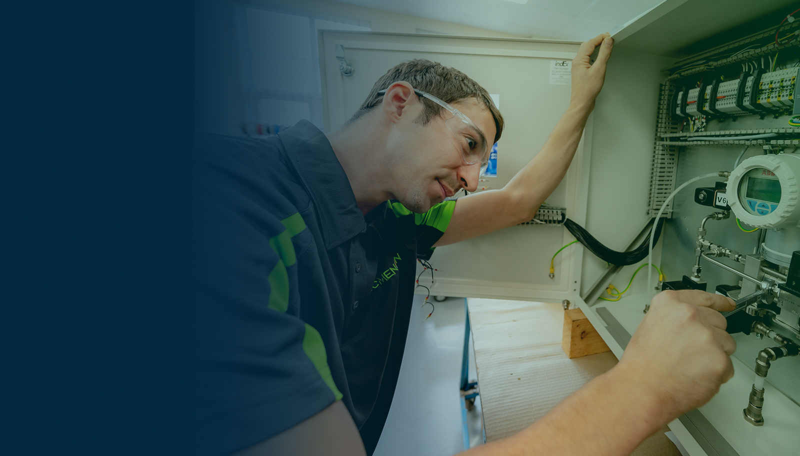 McMenon technician working on an industrial control panel